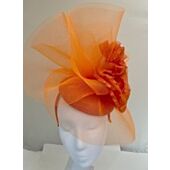 Orange fascinator with crin waves with a large flower