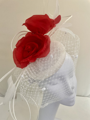 White and red fascinator with roses, veiling, and quills