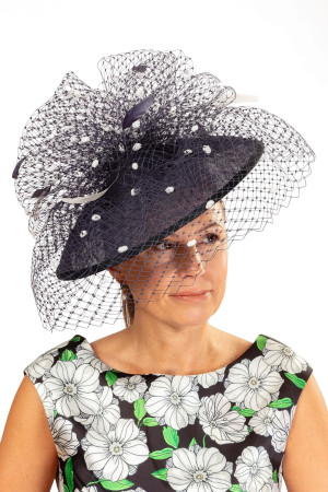 Navy blue fascinator, adorned with white spotted veiling